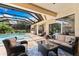 Relaxing outdoor living area with comfortable seating, screened pool and access to the outdoor kitchen at 2152 Majestic Oaks Blvd, Clearwater, FL 33759