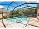 Beautiful screened-in pool and spa surrounded by lush landscaping creating a private backyard oasis at 2152 Majestic Oaks Blvd, Clearwater, FL 33759