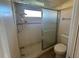 Bathroom featuring a shower stall with glass door and a white toilet at 2178 Calcutta Rd, Punta Gorda, FL 33983