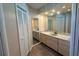 Neutral bathroom featuring double vanity, wall to wall mirrors, and ample cabinet storage at 2178 Calcutta Rd, Punta Gorda, FL 33983
