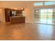 Spacious living area with tile floors leading to kitchen and glass doors to outside pool at 2178 Calcutta Rd, Punta Gorda, FL 33983