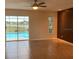 Bright living room featuring tile floors, ceiling fan and sliding glass doors leading to the pool at 2178 Calcutta Rd, Punta Gorda, FL 33983