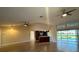 Open-concept living room featuring tile flooring, ceiling fans, and access to the lanai at 2178 Calcutta Rd, Punta Gorda, FL 33983