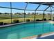 Relaxing screened-in pool with a beautiful view of the lake and well-manicured lawn at 2178 Calcutta Rd, Punta Gorda, FL 33983