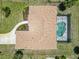 Aerial view of home and screened pool showcasing proximity to other homes at 251 Broadmoor Ln, Rotonda West, FL 33947