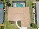 Aerial view of the roof, backyard, pool, and landscaping of the home at 251 Broadmoor Ln, Rotonda West, FL 33947