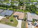 Aerial view of home showcasing landscaping, long driveway and neighboring houses with pools at 251 Broadmoor Ln, Rotonda West, FL 33947