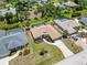 Aerial view of home and neighborhood showcasing mature landscaping and nearby homes at 251 Broadmoor Ln, Rotonda West, FL 33947