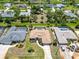 Aerial view of home showcasing landscaping, long driveway and neighboring houses with pools at 251 Broadmoor Ln, Rotonda West, FL 33947