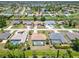 Aerial view showcases homes in a neighborhood, some featuring screened pools at 251 Broadmoor Ln, Rotonda West, FL 33947