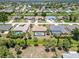 Aerial view of home showcasing a screened pool and beautiful backyard in a waterfront community at 251 Broadmoor Ln, Rotonda West, FL 33947