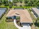 Aerial view of home showcasing landscaping, roof, and screened in pool at 251 Broadmoor Ln, Rotonda West, FL 33947