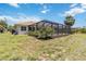 The home has a screened-in pool with a well maintained grassy lawn at 251 Broadmoor Ln, Rotonda West, FL 33947