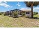 View of the backyard and screened-in pool area at 251 Broadmoor Ln, Rotonda West, FL 33947
