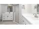 Contemporary bathroom with dual sinks, modern fixtures and a glass shower at 251 Broadmoor Ln, Rotonda West, FL 33947