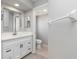 This bathroom has a white vanity with a sink, mirror, and a separate toilet room at 251 Broadmoor Ln, Rotonda West, FL 33947