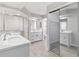 Modern bathroom featuring dual sinks, modern fixtures, and a step-in shower at 251 Broadmoor Ln, Rotonda West, FL 33947