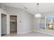 The dining room features tile flooring, a modern chandelier, and a large window overlooking the exterior at 251 Broadmoor Ln, Rotonda West, FL 33947