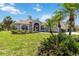 Charming single-story home featuring lush landscaping, a screened-in porch, and a well-manicured lawn at 251 Broadmoor Ln, Rotonda West, FL 33947