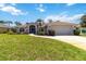 Charming single-story home boasts well-manicured lawn, landscaping, and attached two-car garage at 251 Broadmoor Ln, Rotonda West, FL 33947