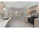 Spacious kitchen featuring stainless steel appliances, tile flooring, and ample natural light from windows at 251 Broadmoor Ln, Rotonda West, FL 33947
