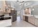 Open kitchen with stainless steel appliances, light wood cabinets, tile floor, and bright countertops at 251 Broadmoor Ln, Rotonda West, FL 33947