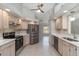 Spacious kitchen with stainless steel appliances and adjacent living area, perfect for entertaining at 251 Broadmoor Ln, Rotonda West, FL 33947