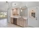 Bright kitchenette featuring modern stainless steel appliances and white countertops with access to other rooms at 251 Broadmoor Ln, Rotonda West, FL 33947