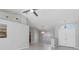 Bright living room with neutral walls, tile flooring, and a contemporary ceiling fan at 251 Broadmoor Ln, Rotonda West, FL 33947