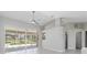 Bright living room with pool views from sliding glass doors at 251 Broadmoor Ln, Rotonda West, FL 33947