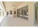 The covered patio features tile flooring, a ceiling fan, and access to the pool area at 251 Broadmoor Ln, Rotonda West, FL 33947