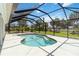 Inviting screened-in pool with a sunny backyard and a blue sky at 251 Broadmoor Ln, Rotonda West, FL 33947