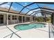 Sparkling kidney-shaped pool under a screened enclosure and sunny skies at 251 Broadmoor Ln, Rotonda West, FL 33947