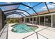 This in-ground pool is screened in and includes steps for easy access at 251 Broadmoor Ln, Rotonda West, FL 33947