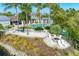 Gorgeous aerial view of community amenities, including a pool, fire pit, and lounge area surrounded by tropical landscaping at 276 Saint Lucia Dr # 101, Bradenton, FL 34209