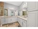 Spacious bathroom with dual sinks, granite counters, tiled floors, a glass-enclosed shower, and a large mirror at 276 Saint Lucia Dr # 101, Bradenton, FL 34209
