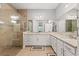 Spacious bathroom with dual sinks, granite counters, tiled floors, a glass-enclosed shower, and a large mirror at 276 Saint Lucia Dr # 101, Bradenton, FL 34209