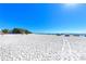 Expansive beach views under a clear blue sky invite relaxation and coastal enjoyment at 276 Saint Lucia Dr # 101, Bradenton, FL 34209