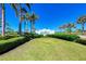 Landscaped lawn with view of the community's beach club entrance at 276 Saint Lucia Dr # 101, Bradenton, FL 34209