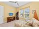 Comfortable bedroom with window views, ceiling fan, and book display at 276 Saint Lucia Dr # 101, Bradenton, FL 34209