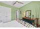 Green bedroom with a ceiling fan, ensuite and comfortable furnishings at 276 Saint Lucia Dr # 101, Bradenton, FL 34209
