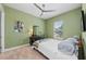 Green guest bedroom with a neutral ceiling fan, and a view to the outdoors at 276 Saint Lucia Dr # 101, Bradenton, FL 34209