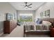 Spacious bedroom with a large window offering scenic views, complemented by a ceiling fan and stylish furnishings at 276 Saint Lucia Dr # 101, Bradenton, FL 34209