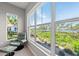 Bedroom sitting area featuring large windows with scenic views of lush greenery and the water in the distance at 276 Saint Lucia Dr # 101, Bradenton, FL 34209