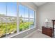 Bedroom featuring an expansive window with scenic views of lush greenery and the water in the distance at 276 Saint Lucia Dr # 101, Bradenton, FL 34209