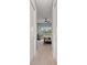 Hallway with a view into a bedroom featuring a scenic view, neutral tones, and carpeted floors at 276 Saint Lucia Dr # 101, Bradenton, FL 34209