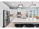 Modern kitchen with a large island, stainless steel appliances, and granite countertops at 276 Saint Lucia Dr # 101, Bradenton, FL 34209