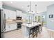 Modern kitchen features stainless steel appliances, white cabinetry, and an island with bar seating at 276 Saint Lucia Dr # 101, Bradenton, FL 34209