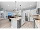 Modern kitchen features stainless steel appliances, white cabinetry, and a large island with pendant lighting at 276 Saint Lucia Dr # 101, Bradenton, FL 34209