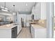Bright kitchen featuring stainless steel appliances, quartz countertops, and white cabinets at 276 Saint Lucia Dr # 101, Bradenton, FL 34209